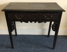 A Continental oak carved single drawer desk. Est.