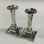 A pair of heavy Sterling silver square based candl