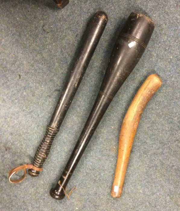 A group of three old wooden truncheons. Est. £20 -