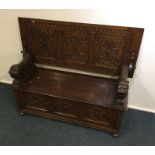 A good oak hinged top settle on bun feet. Est. £20