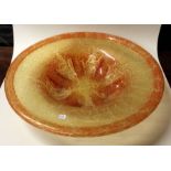 A stylish orange glass fruit bowl of textured form