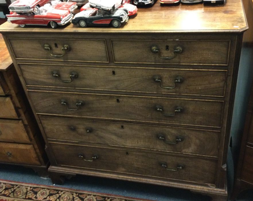 A Georgian mahogany six drawer chest with cut corn