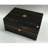 A calamander wood and brass mounted tea caddy. Est