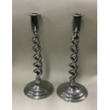 A pair of chrome barley twist candlesticks. Est. £