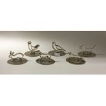 A good set of six silver menu holders in the form