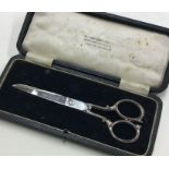 A cased pair of silver handled scissors. Sheffield