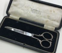 A cased pair of silver handled scissors. Sheffield