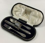 A heavy cased silver three piece christening set.