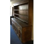 A massive pine dresser. Est. £100 - £150.