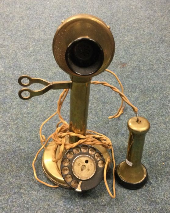 An old brass telephone. Est. £20 - £30.