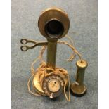 An old brass telephone. Est. £20 - £30.