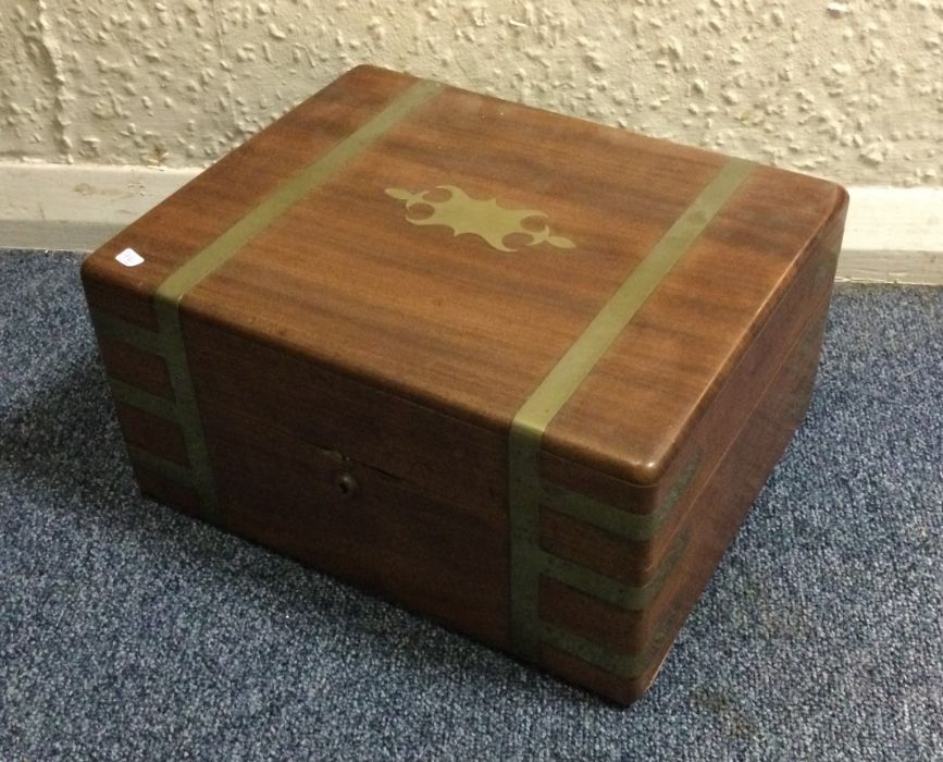 A heavy mahogany and brass inlaid hinged top writi