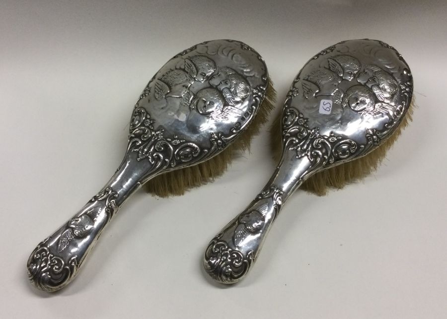 A good pair of silver mounted hairbrushes decorate