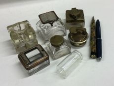 A box containing travelling inkwells, pens etc. Es