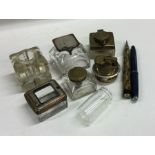A box containing travelling inkwells, pens etc. Es