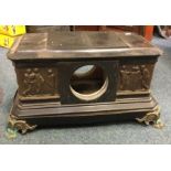 A large slate clock mount decorated with brass fig