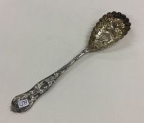 A Victorian silver fruit spoon decorated with frui