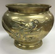 A Chinese brass jardinière decorated with dragons