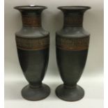 A pair of spelter vases decorated with scrolls and