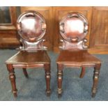 A good pair of mahogany hall chairs on turned supp