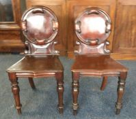 A good pair of mahogany hall chairs on turned supp