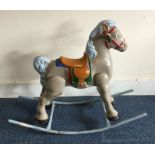 A vintage painted rocking horse decorated in brigh