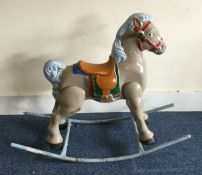 A vintage painted rocking horse decorated in brigh