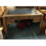 A Victorian writing desk on fitted supports with l