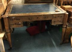 A Victorian writing desk on fitted supports with l