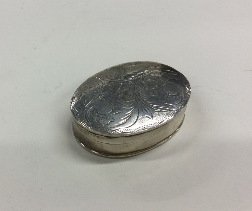 An oval silver hinged top box with engraved decora