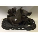 A carved wooden figure of an ox on wooden base. Es