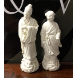 A pair of Chinese figures decorated win white grou