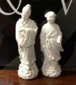 A pair of Chinese figures decorated win white grou