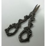 A heavy pair of grape scissors with textured handl