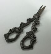 A heavy pair of grape scissors with textured handl