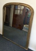 A large gilt over mantle mirror. Est. £40 - £60.