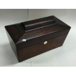 A rosewood shaped tea caddy with fitted interior.