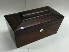 A rosewood shaped tea caddy with fitted interior.