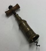An old brass mounted corkscrew. Est. £30 - £40.