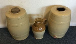 A pair of barrel shaped urns together with a jug.
