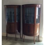 A good pair of bow front glazed cabinets with beve
