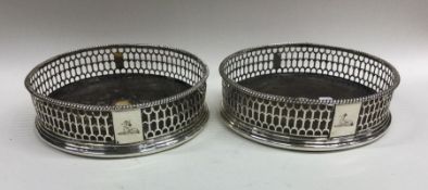 A pair of good Georgian silver pierced wine coaste