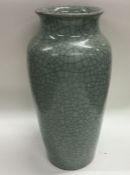 A tall crackleware vase of celadon design. Approx.