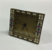 A stylish brass and enamelled mantle clock with gi