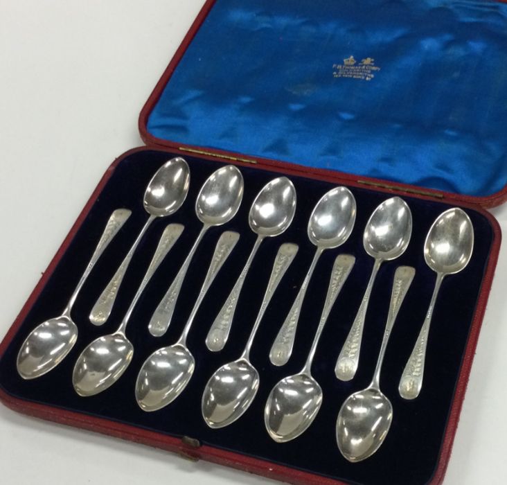 A good set of twelve bright cut silver spoons in f