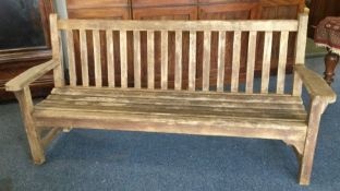 A large teak slat back garden bench. Est. £50 - £8