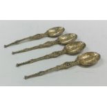 A heavy set of four chased silver anointing spoons