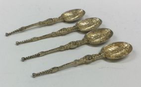 A heavy set of four chased silver anointing spoons