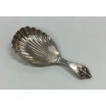 A heavy fancy silver caddy spoon with fluted bowl.