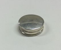 A plain circular silver pill box with hinged top.